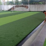 Installation of black joint tape for artificial turf seam bonding