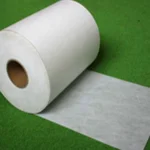 Installation of white joint tape for artificial turf during sports field construction